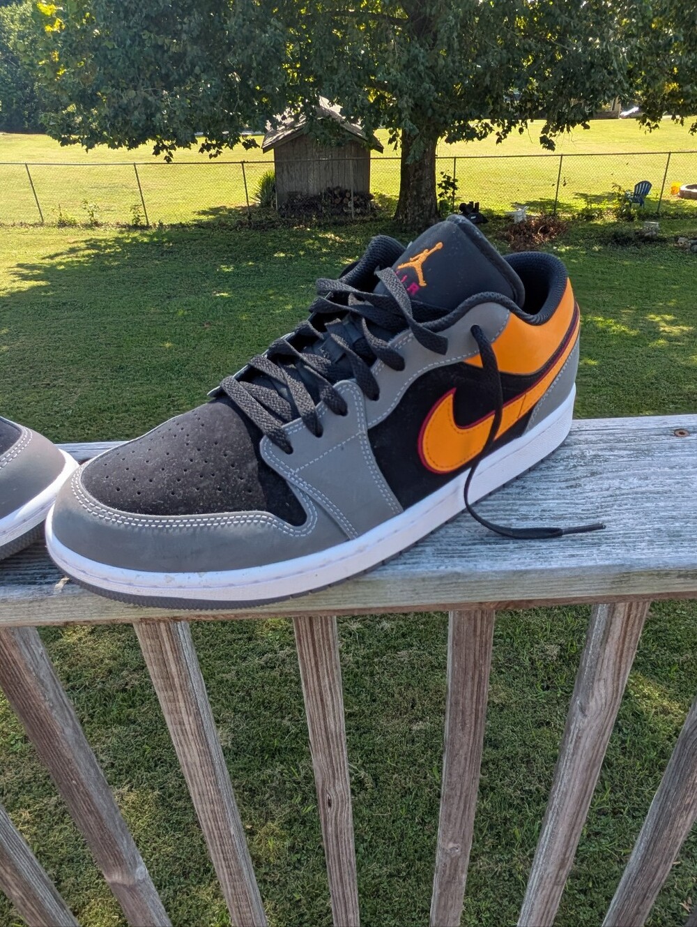 Nike Jordan's Men’s Black & Gray Low-Top Sneakers with Orange Swoosh